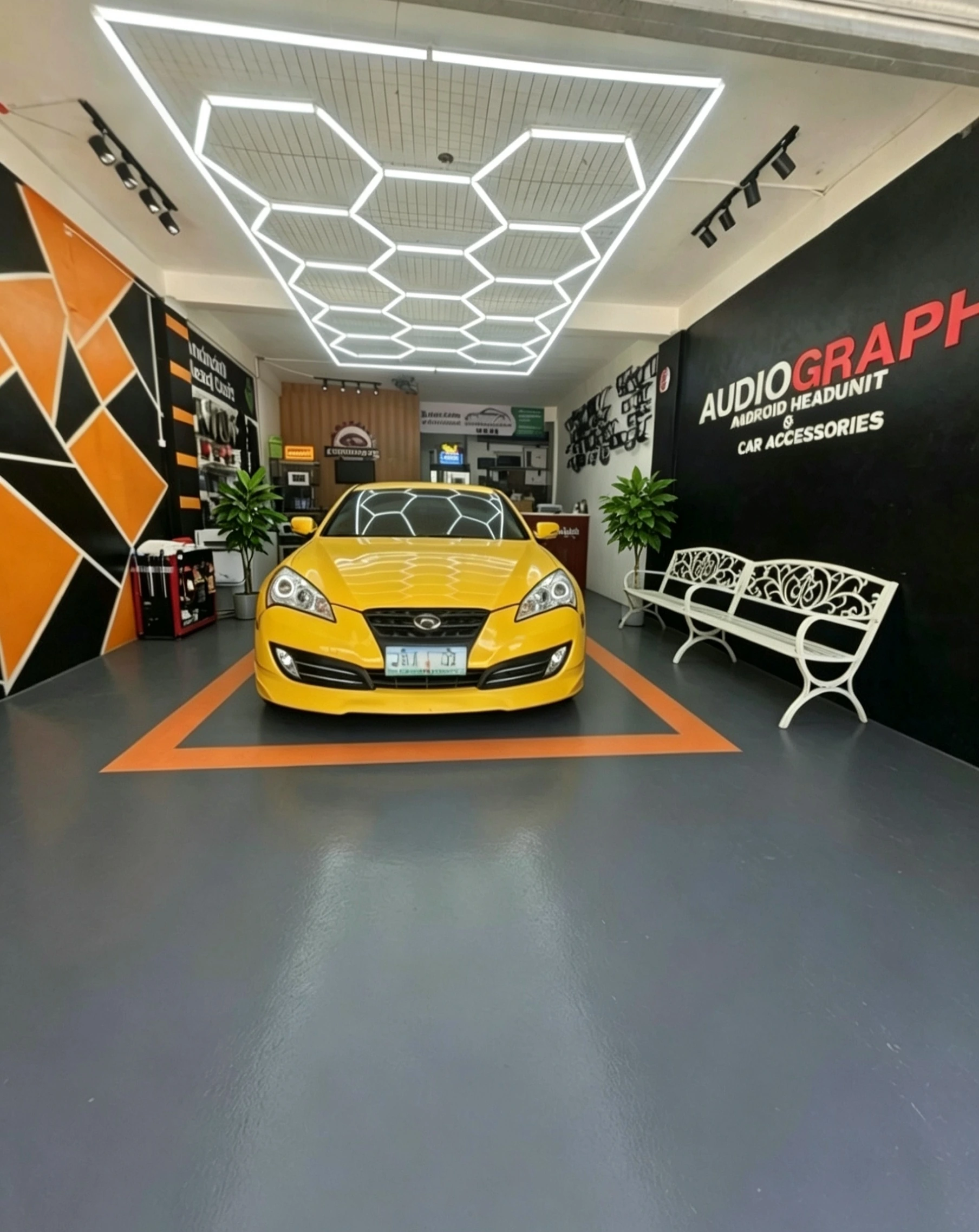 Actual Audiograph showroom with yellow display car in Dasmariñas, Cavite